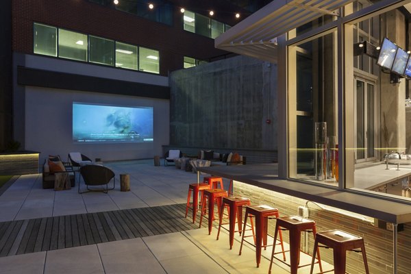 Outdoor patio area with modern seating and greenery at Anthology Apartments, offering a relaxing communal space for residents