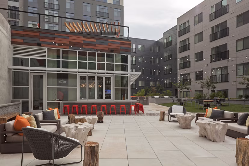 Patio area with modern seating and string lights at Anthology Apartments, a luxury Greystar community