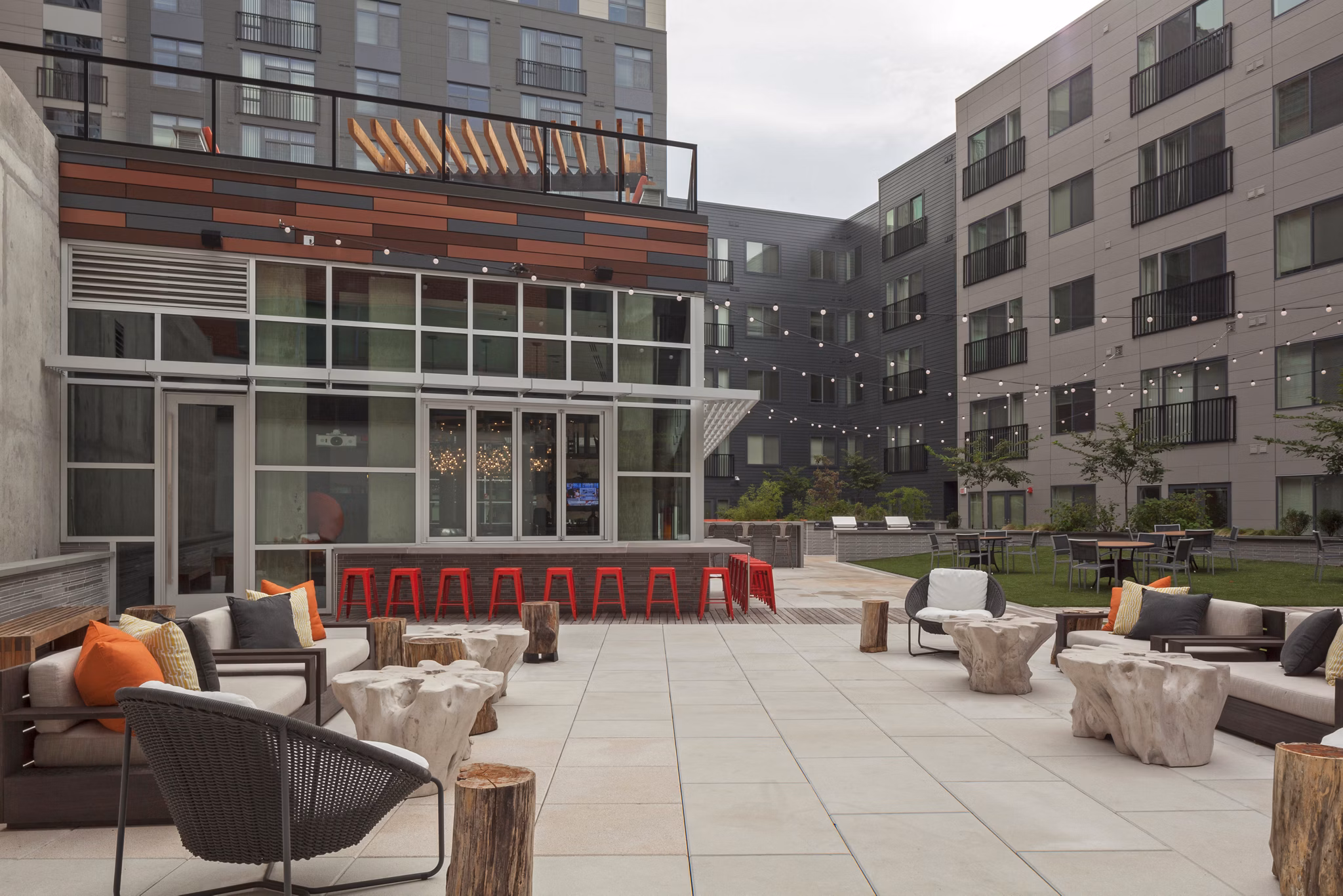 Patio area with modern seating and string lights at Anthology Apartments, a luxury Greystar community