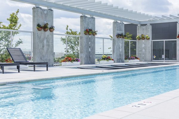 Sparkling outdoor pool at Anthology Apartments offering luxury relaxation and scenic views