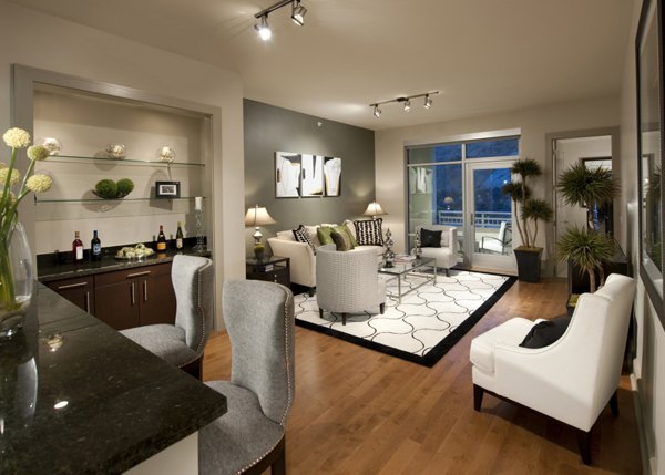 Elegant living room with chic furnishings and large windows in Ashton San Francisco Apartments