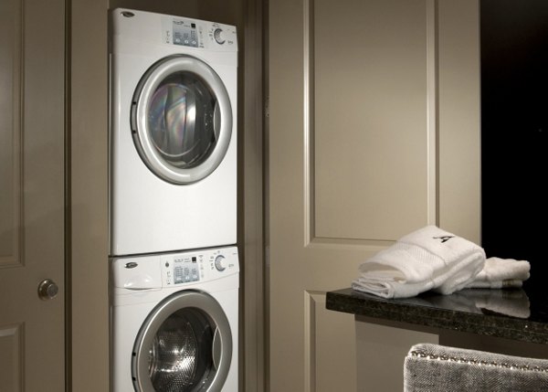 Laundry room with modern washers and dryers at Ashton San Francisco Apartments