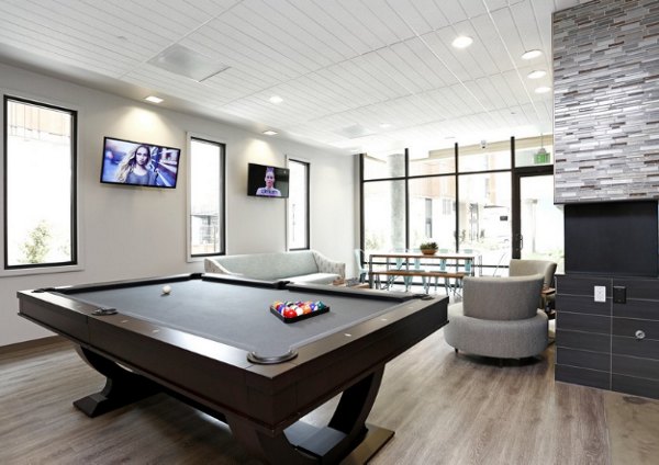 Game room with billiards and arcade games at Waterbend Apartments