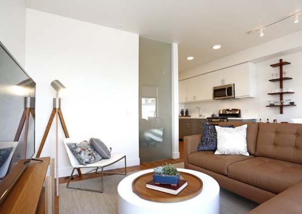 Cozy living room with modern decor and natural light at Waterbend Apartments: luxury living in a serene Greystar community
