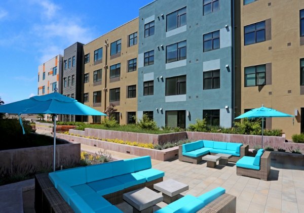 Patio view at Waterbend Apartments featuring comfortable seating and lush greenery, a perfect outdoor retreat for residents