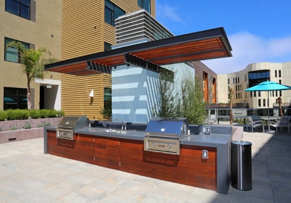 Modern outdoor grill area with sleek stainless steel appliances at Waterbend Apartments, perfect for entertaining and dining