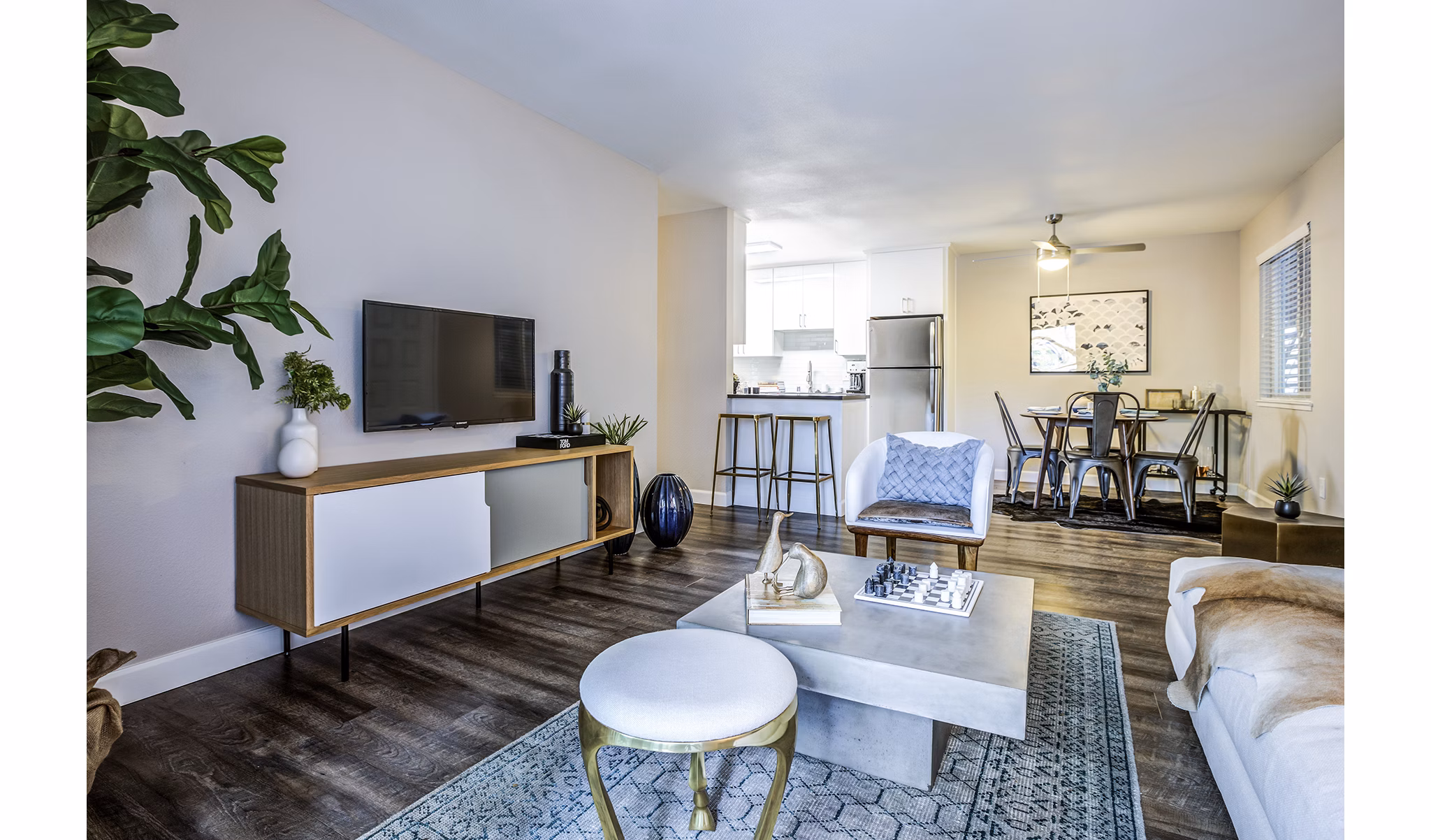 Spacious living room featuring modern furnishings and large windows at Avana Almaden Apartments
