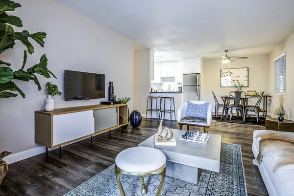 Spacious living room featuring modern furnishings and large windows at Avana Almaden Apartments