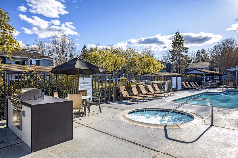Outdoor grill area with modern seating at Avana Almaden Apartments, a luxury Greystar property