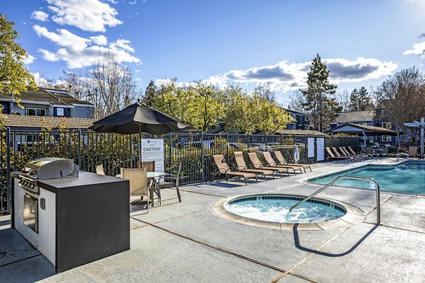 Outdoor grill area with modern seating at Avana Almaden Apartments, a luxury Greystar property