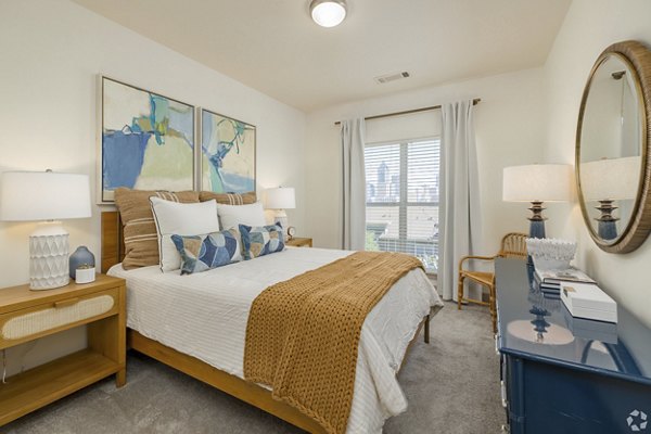 Cozy bedroom with modern furnishings at Pencil Factory Flats Apartments