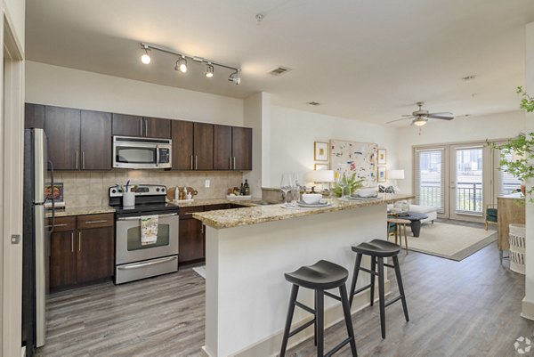 Modern kitchen with stainless steel appliances in Pencil Factory Flats Apartments