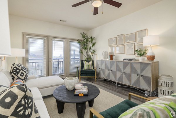 Living room with stylish decor and hardwood floors at Pencil Factory Flats Apartments