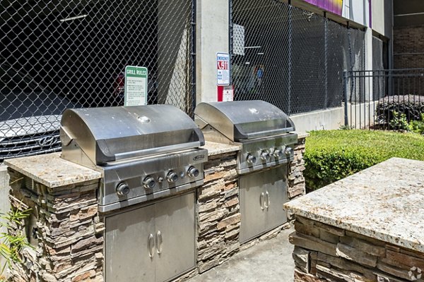 Inviting patio at Pencil Factory Flats Apartments featuring modern seating and lush greenery