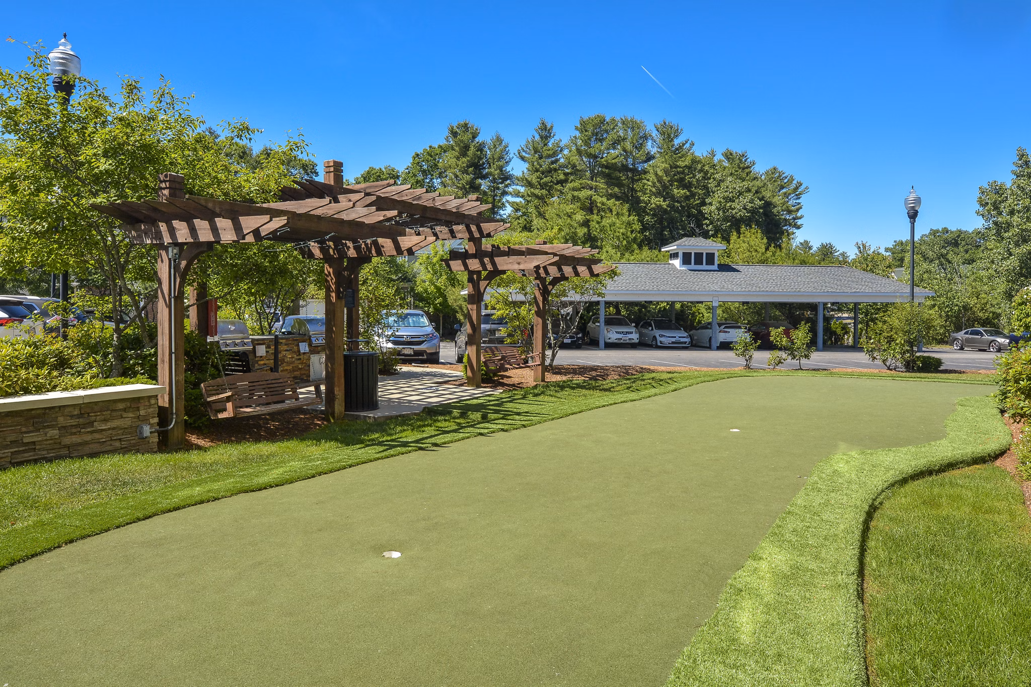 Sport court featuring basketball hoops at Lux at Stoughton Apartments, ideal for fitness and recreation enthusiasts