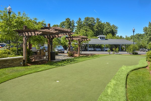 Sport court featuring basketball hoops at Lux at Stoughton Apartments, ideal for fitness and recreation enthusiasts