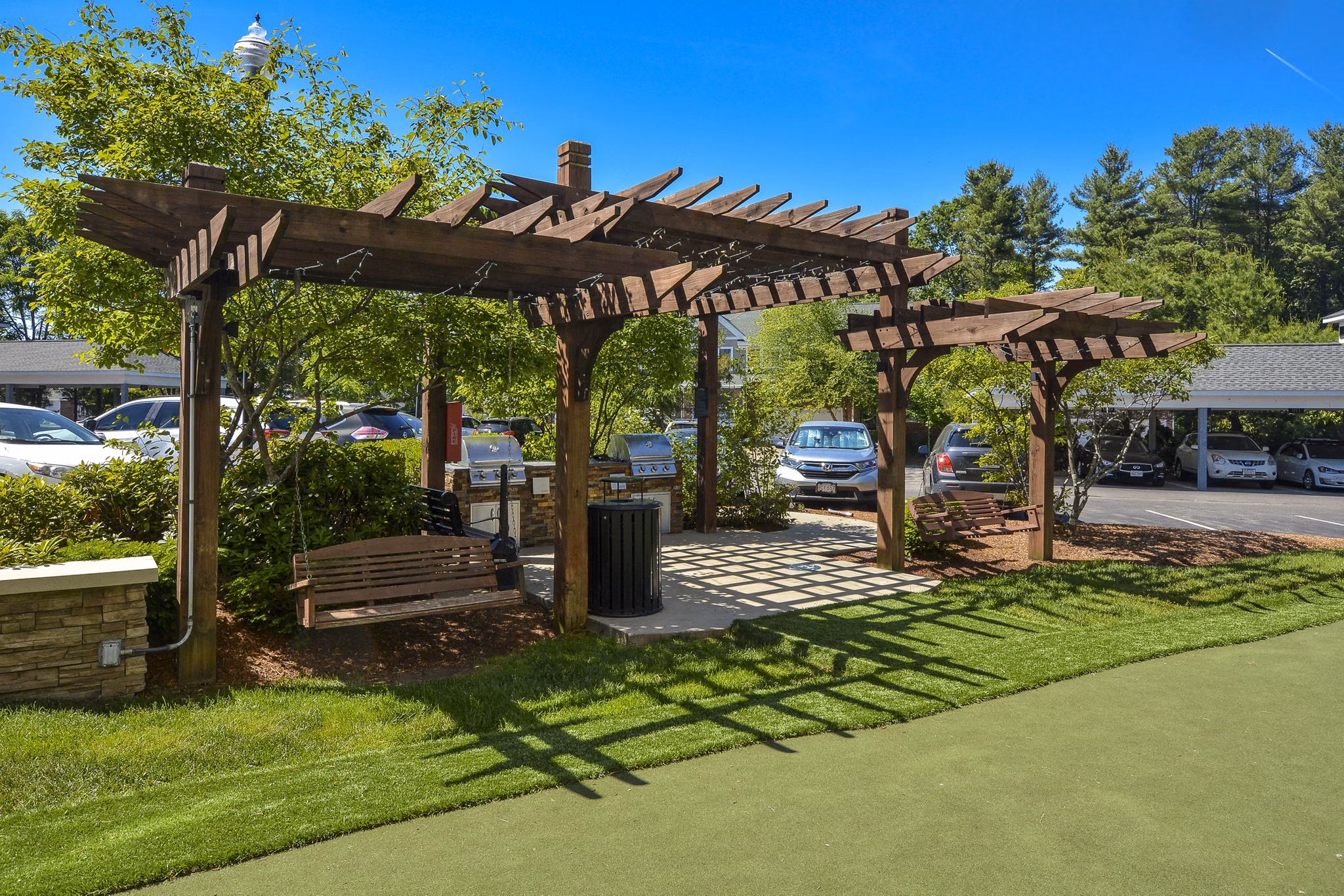 Courtyard view at Lux at Stoughton Apartments featuring lush landscaping and modern design Perfect for relaxation in this luxury community