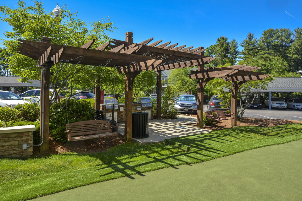 Courtyard view at Lux at Stoughton Apartments featuring lush landscaping and modern design Perfect for relaxation in this luxury community
