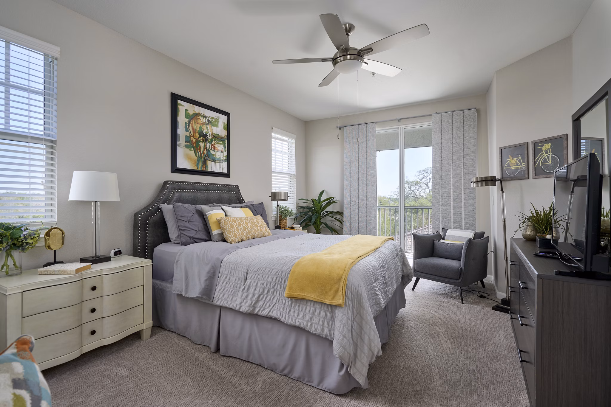Elegant bedroom featuring modern decor and large windows in Arietta Apartments