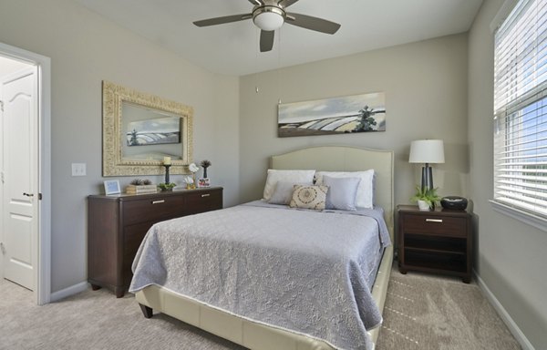 Cozy bedroom with modern design elements at Arietta Apartments, featuring a plush bed and elegant decor in a luxury setting