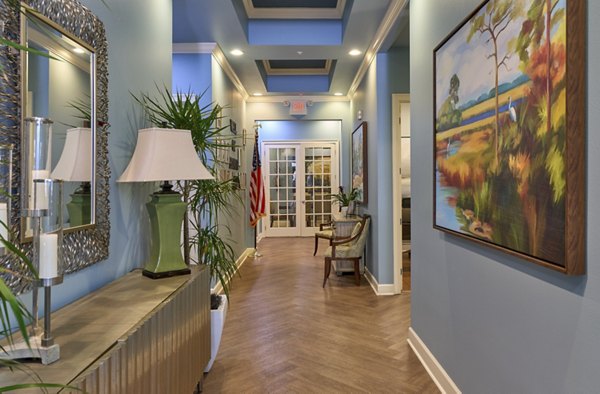 Arietta Apartments: Modern clubhouse with stylish seating and large windows creating a welcoming community space
