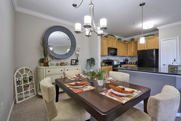 Arietta Apartments: Elegant dining room with modern furnishings and ambient lighting in luxury community setting