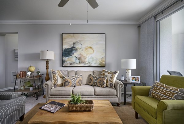 Luxurious living room with modern decor and large windows at Arietta Apartments