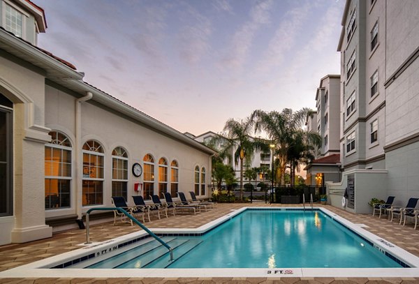 Resort-style pool with lounge chairs at Arietta Apartments, ideal for relaxation and leisure in a luxury setting