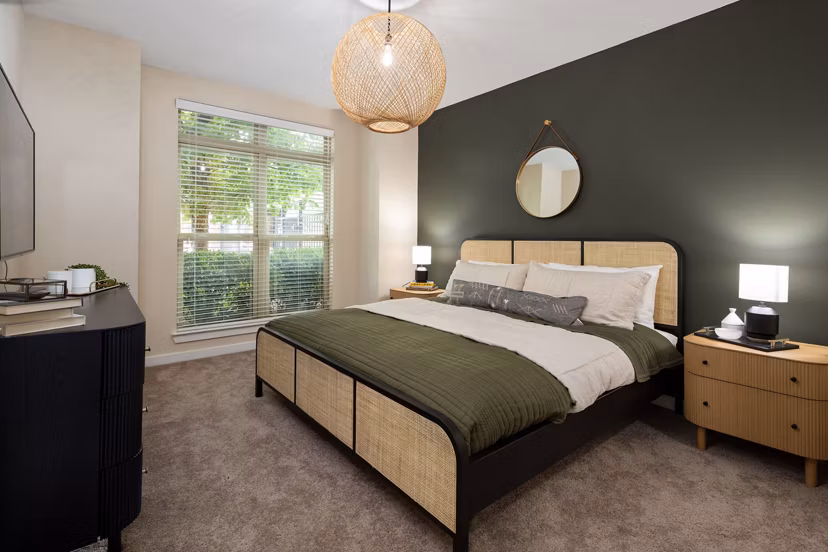 Cozy bedroom featuring large bed, nightstands, and dresser at 400 Belmont Apartments in a luxury setting