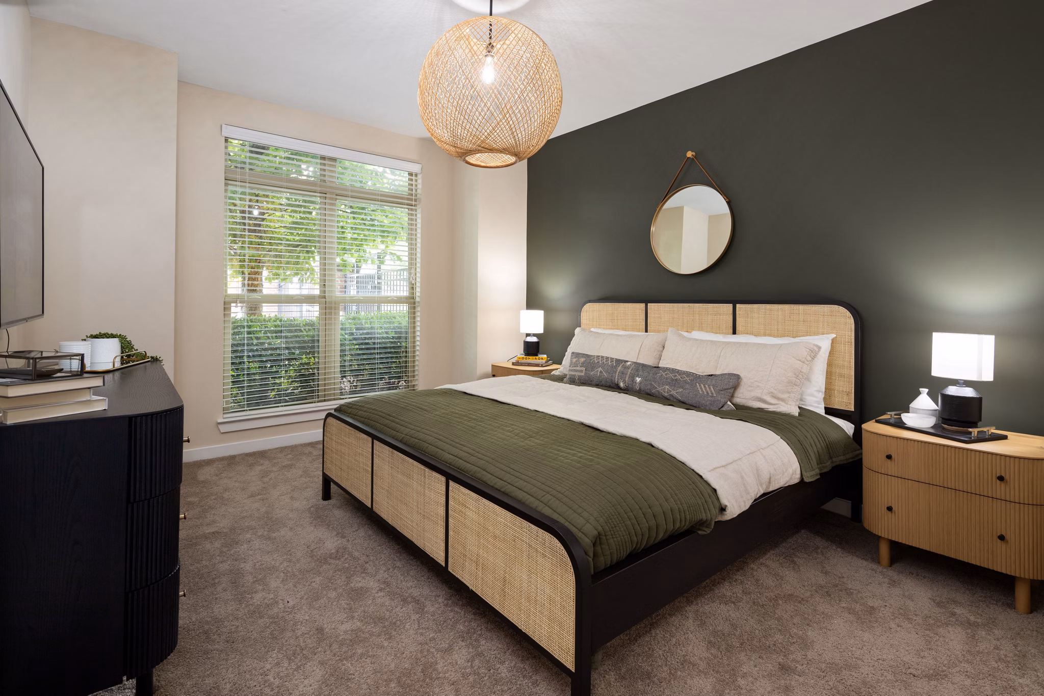Cozy bedroom featuring large bed, nightstands, and dresser at 400 Belmont Apartments in a luxury setting
