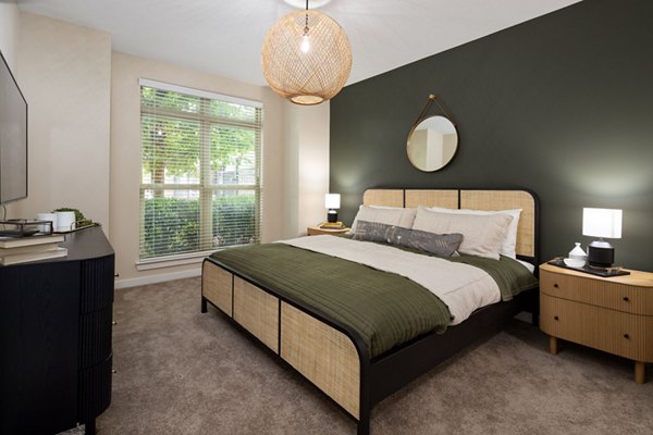 Cozy bedroom featuring large bed, nightstands, and dresser at 400 Belmont Apartments in a luxury setting