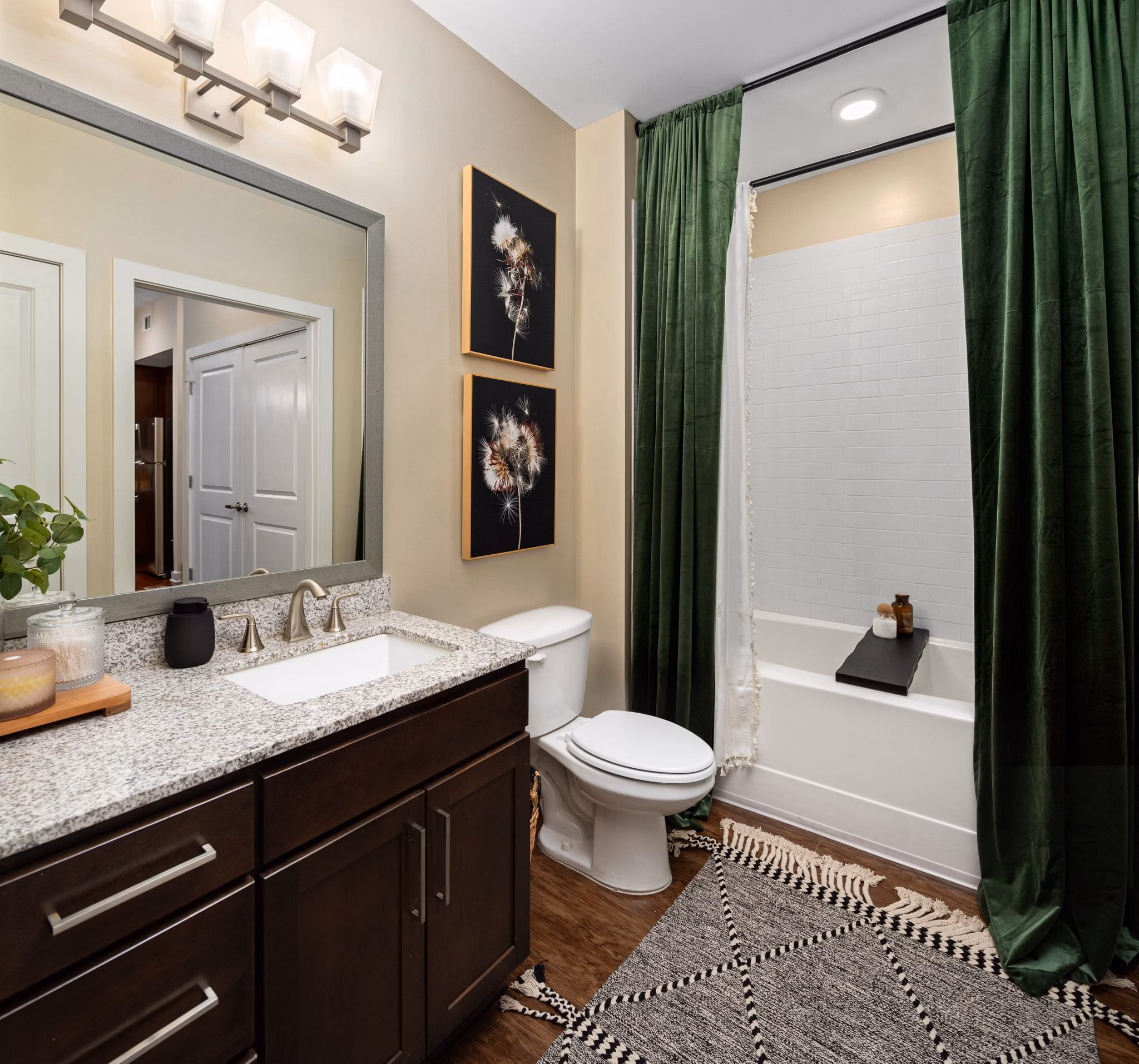 Bathroom with wooden floor, modern vanity, and bathtub at 400 Belmont Apartments