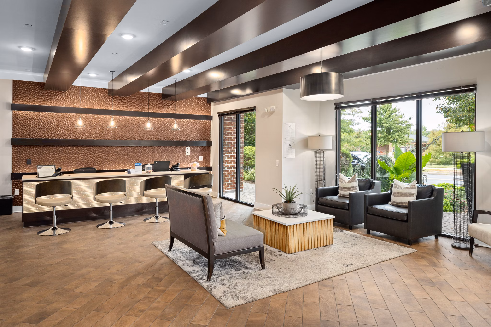 Lobby featuring unique ceiling lights, striped walls, and seating area at 400 Belmont Apartments in Bellevue, WA