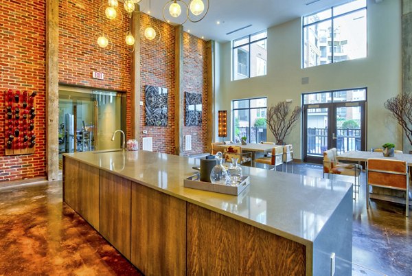 Modern clubhouse with stylish seating and entertainment space at Liberty Warehouse Apartments