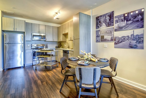 Dining area with modern furniture and elegant lighting at Liberty Warehouse Apartments Perfect for hosting and entertaining guests