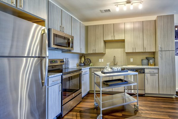 Modern kitchen with stainless steel appliances at Liberty Warehouse Apartments