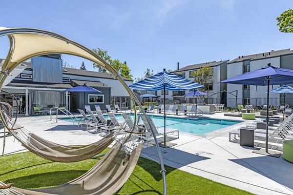 Relaxing outdoor pool at Avana Stoneridge Apartments: Enjoy luxury amenities surrounded by lush landscaping