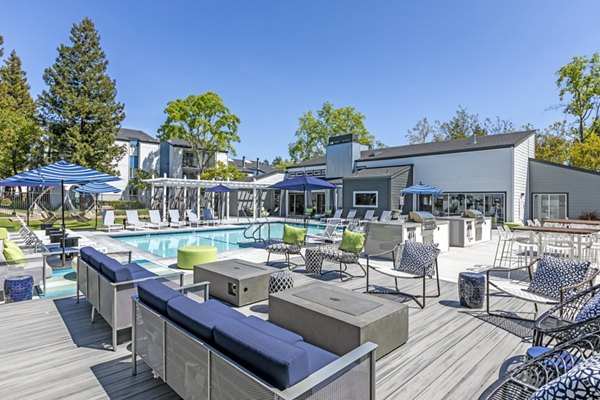 Fire pit seating area at Avana Stoneridge Apartments with cozy lighting and modern design