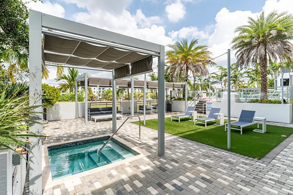 Pool surrounded by lush landscaping at South of Atlantic (SofA) Apartments, offering luxury relaxation in the heart of the city