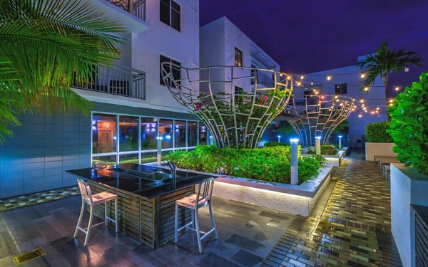 Courtyard with lush greenery and contemporary seating at South of Atlantic (SofA) Apartments, a luxury property by Greystar
