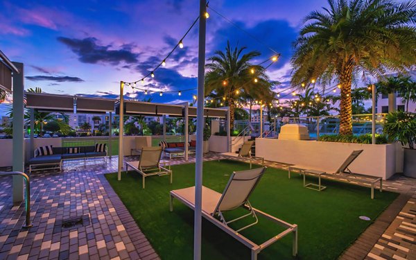 Chic courtyard featuring modern seating and lush greenery at South of Atlantic Apartments