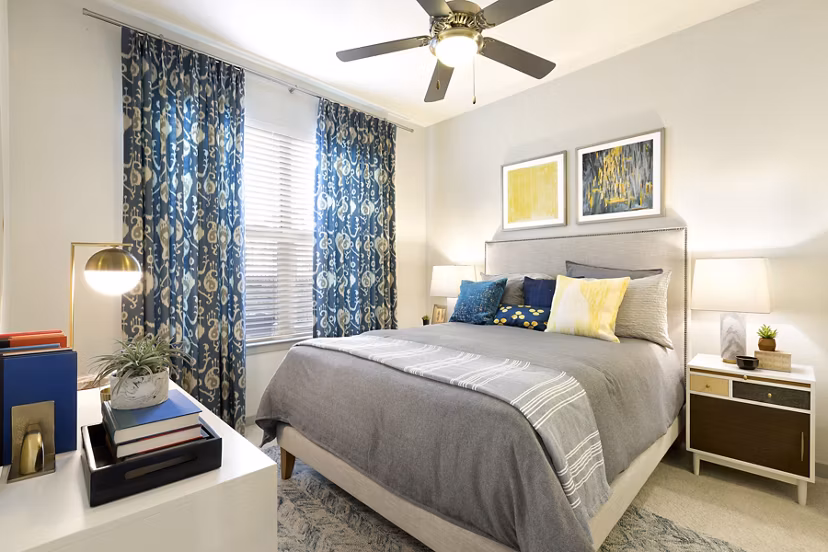 Bedroom showcasing elegant decor and plush bedding at Villas on the Hill Apartments Luxurious space designed for comfort and style