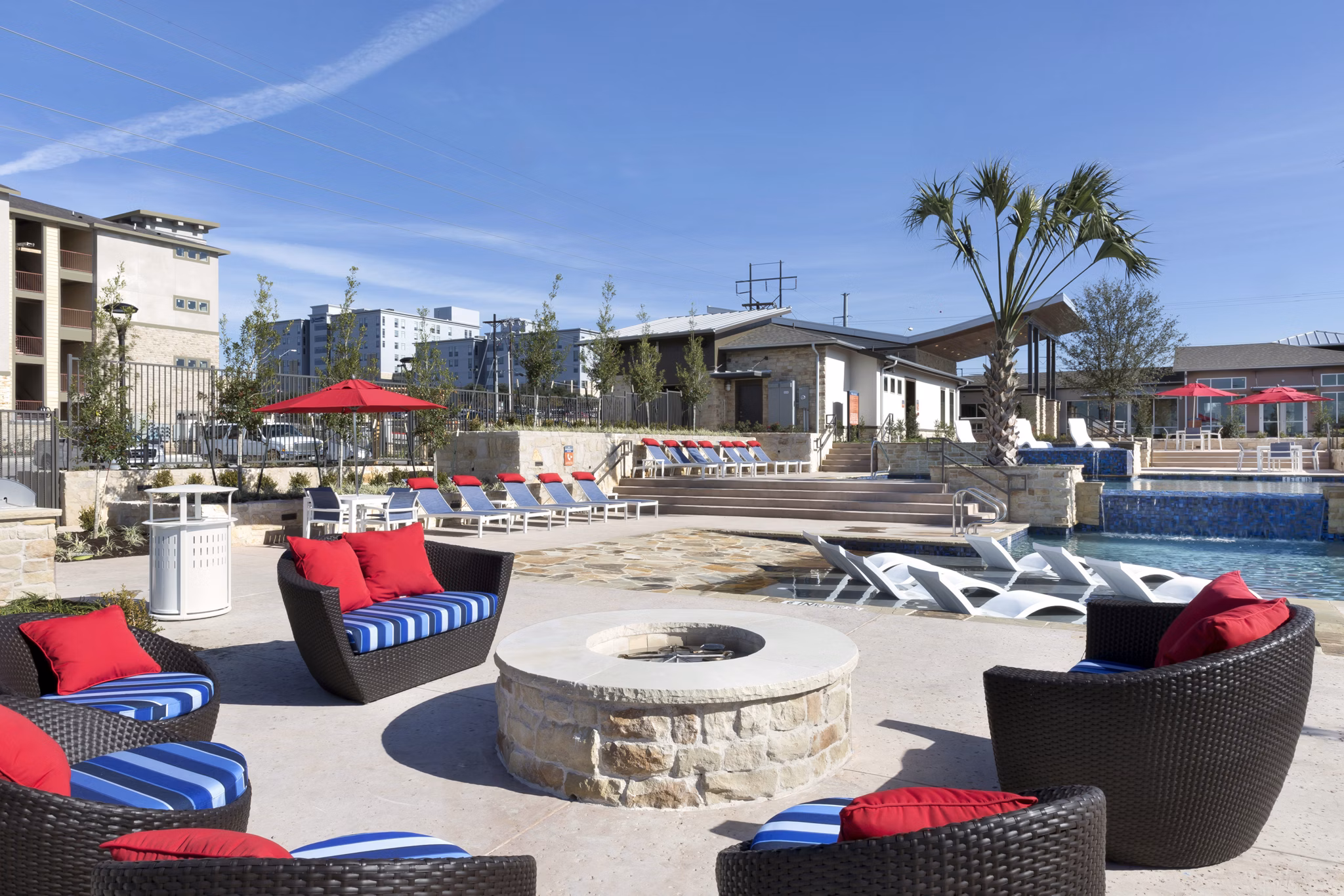Luxurious pool with lounge chairs at Villas on the Hill Apartments offering a serene escape