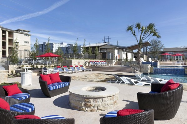 Luxurious pool with lounge chairs at Villas on the Hill Apartments offering a serene escape