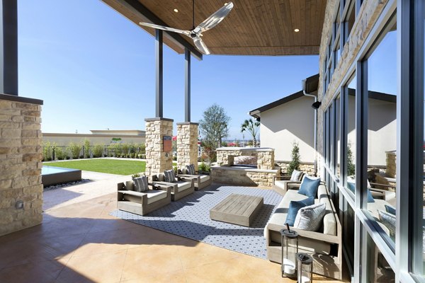 Relaxing patio space with comfortable seating at Villas on the Hill Apartments