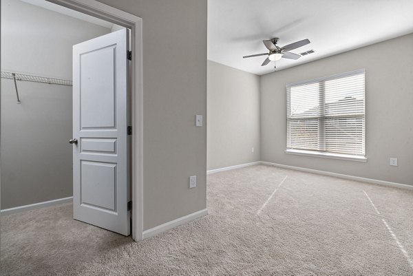 Cozy bedroom with modern decor in Windsor at Tryon Village Apartments, showcasing luxury living spaces