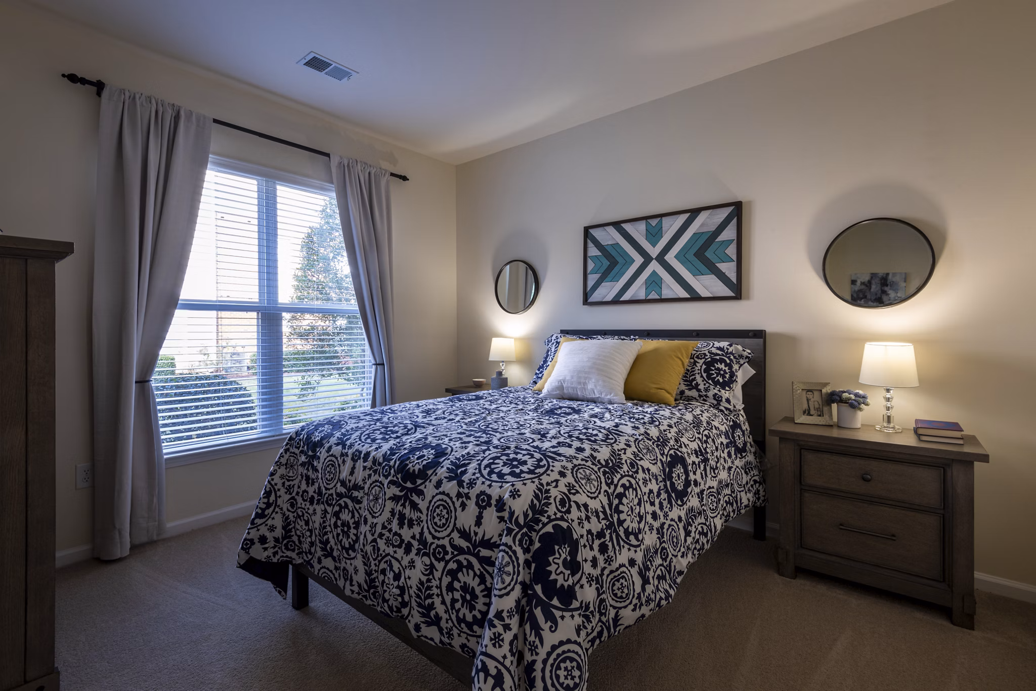 Cozy bedroom with modern decor at Windsor at Tryon Village Apartments, offering luxury living in a welcoming environment