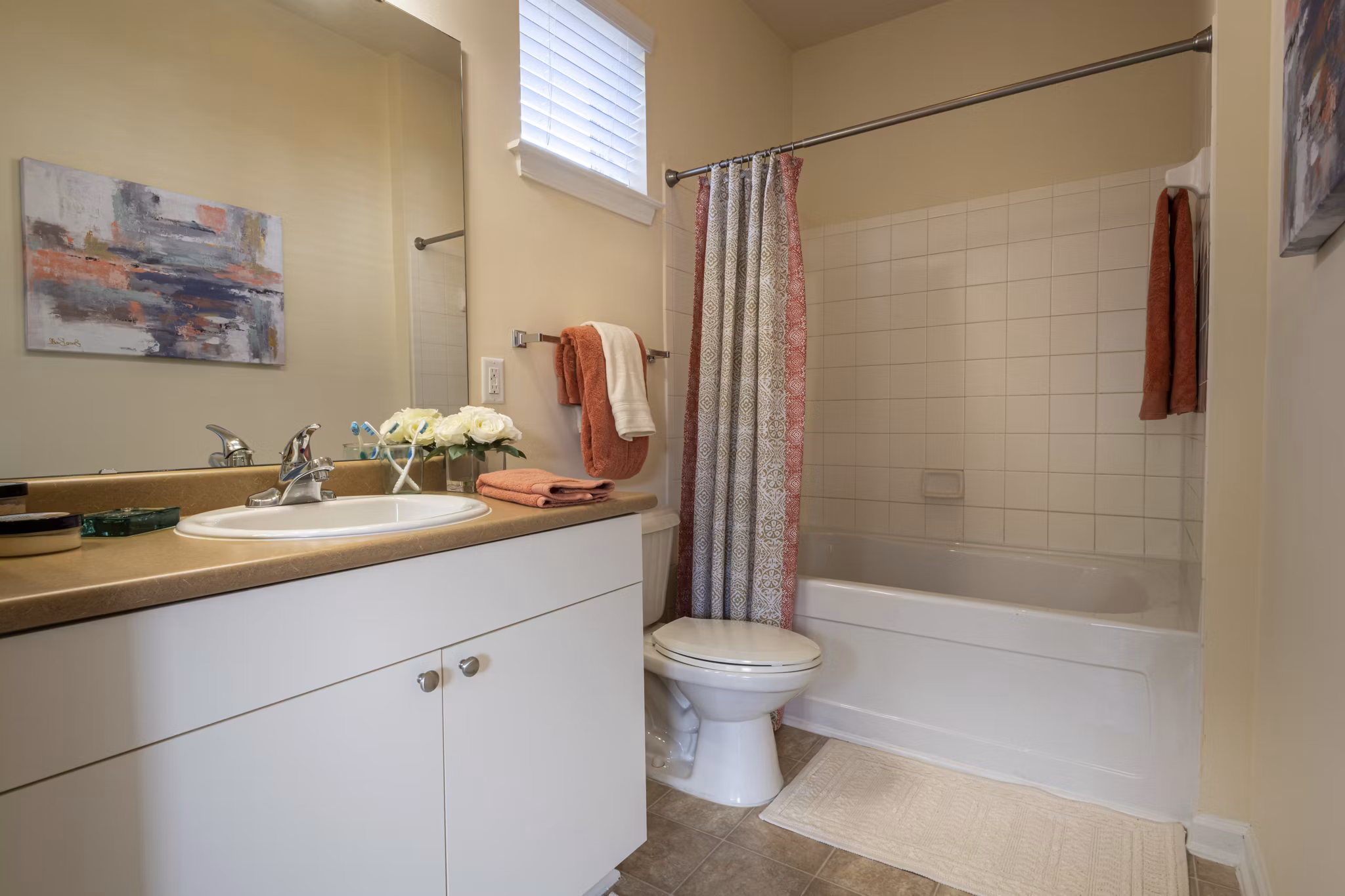 Modern bathroom with spacious vanity and tub in Windsor at Tryon Village Apartments, showcasing luxury apartment living