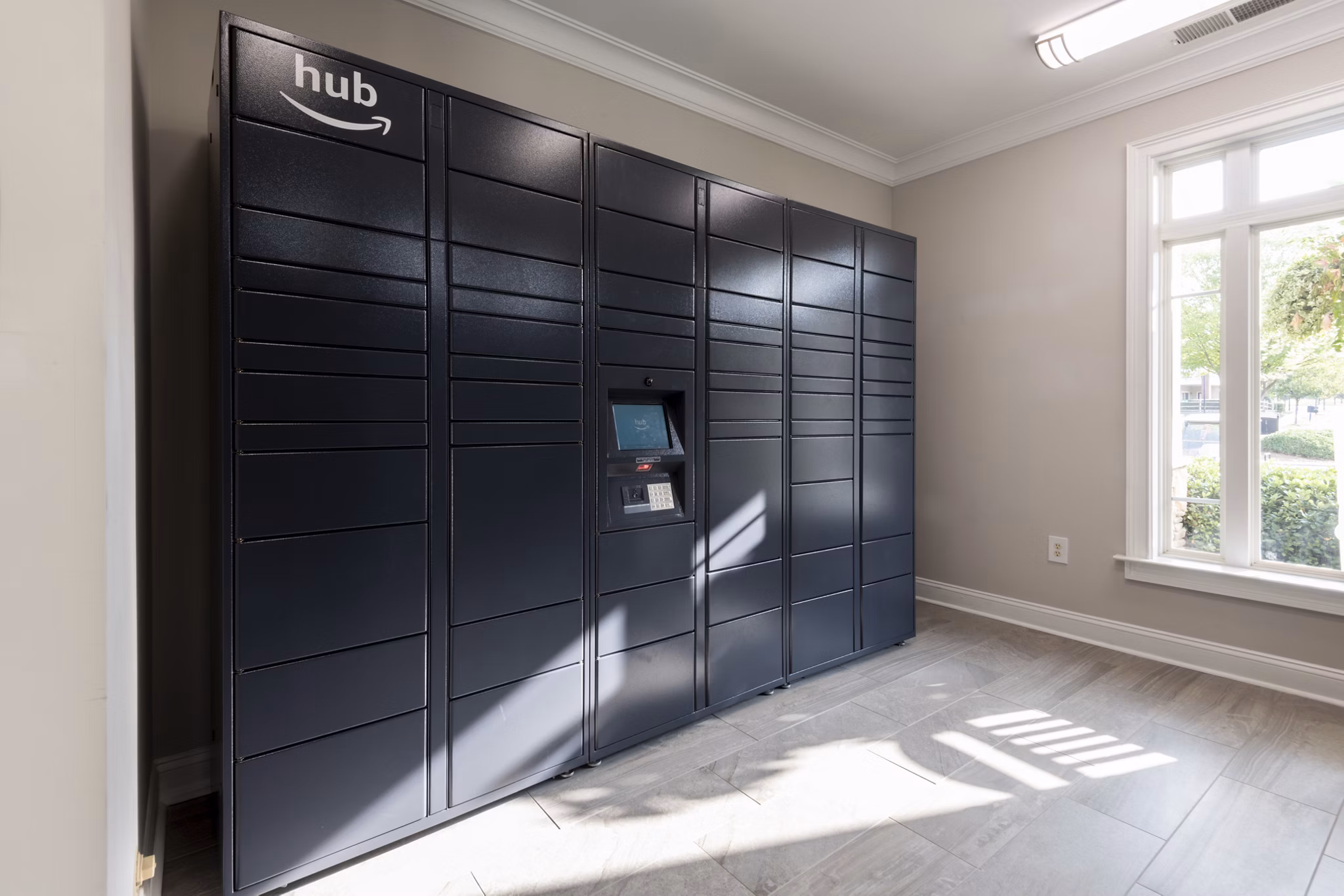 Modern mail room with secure package lockers at Windsor at Tryon Village Apartments