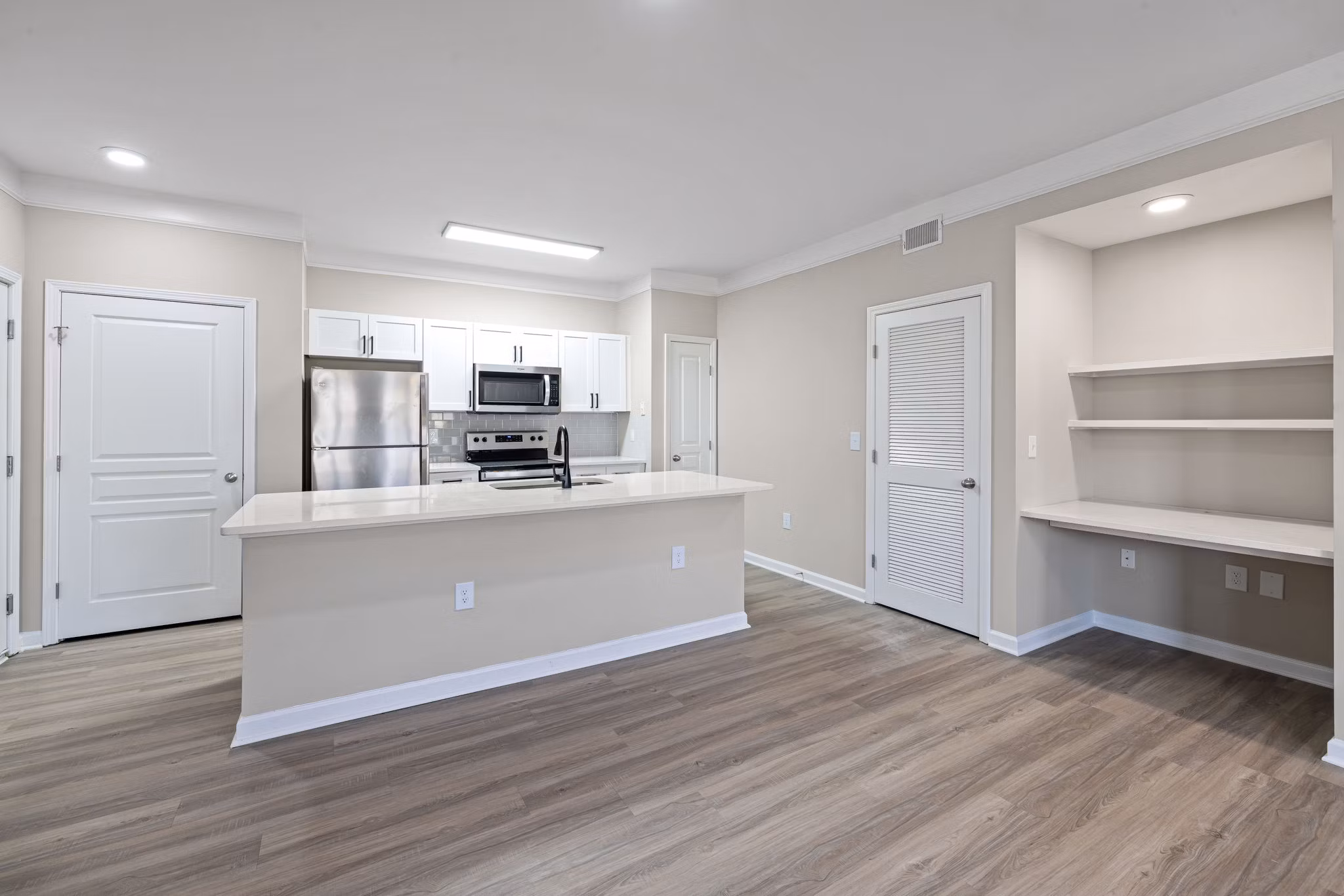 Elegant open-concept kitchen with stainless steel appliances in Windsor at Tryon Village Apartments
